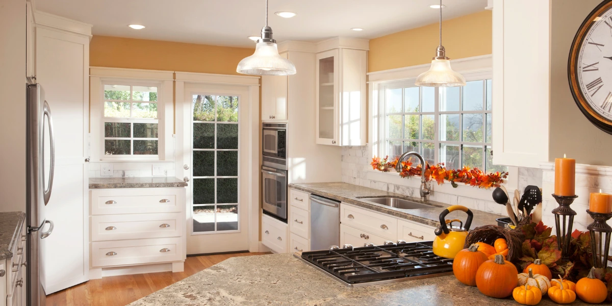 White Kitchen Holiday Cooking Preparation Bright, white kitchen with granite countertops and fall decor, ready for holiday cooking.